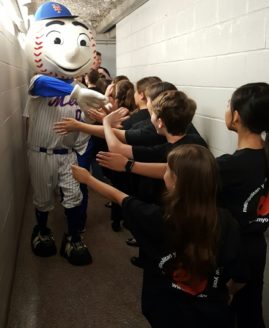 MYO Treble Choirs giving Mr. Met a high-five