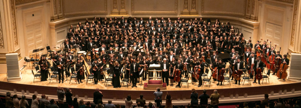 The Suffolk Principal Orchestra and MYO Choirs onstage at Carnegie Hall with Music Directors Edward P. Norris, III and Phil Preddice from May 14, 2017. Photo credit: Musical Memories Photography