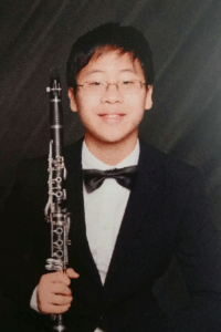 Headshot of Kenny Kim, winner of the 2017-2018 MYO Concerto and Vocal Competition, with his clarinet