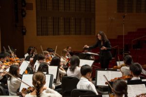 Michelina Sobolewski conducting the Nassau String Orchestra at AUPAC